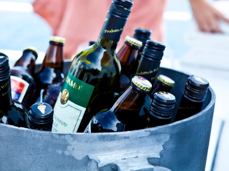 Bottles of wine and beer chilling in an ice bucket