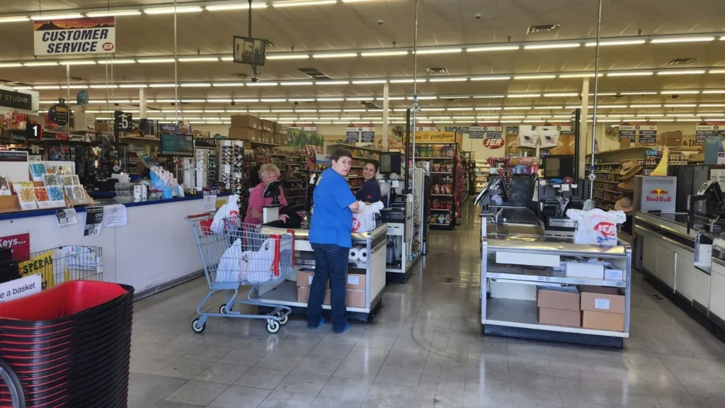 Wide view of the checkout lanes inside Olsens Marketplace IGA