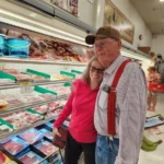 Smiling couple shopping at the meat case at Olsens Marketplace