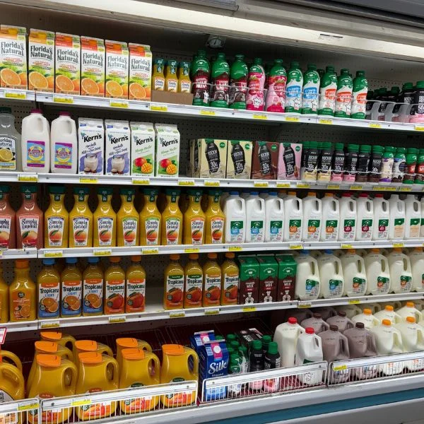 Juice, milk and creamers in the dairy cooler at Olsens Marketplace