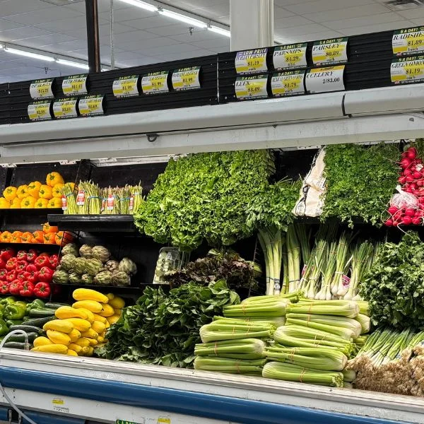 Fresh greens and vegetables in the produce department at Olsens Marketplace