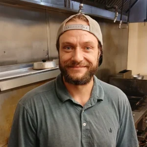 Chad Gibbs, deli manager, smiling in the Tonto Basin Market deli kitchen