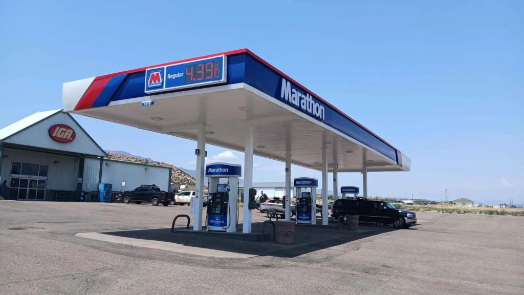 Marathon gas station canopy and fuel pumps at Tonto Basin Market under a blue sky