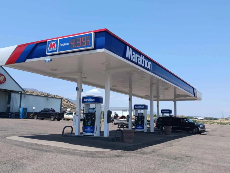 Marathon gas station canopy and fuel pumps at Tonto Basin Market under a blue sky
