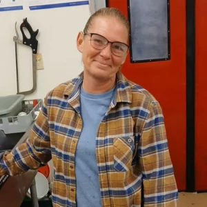 January Workman, meat manager, in a plaid shirt in the Tonto Basin Market meat department