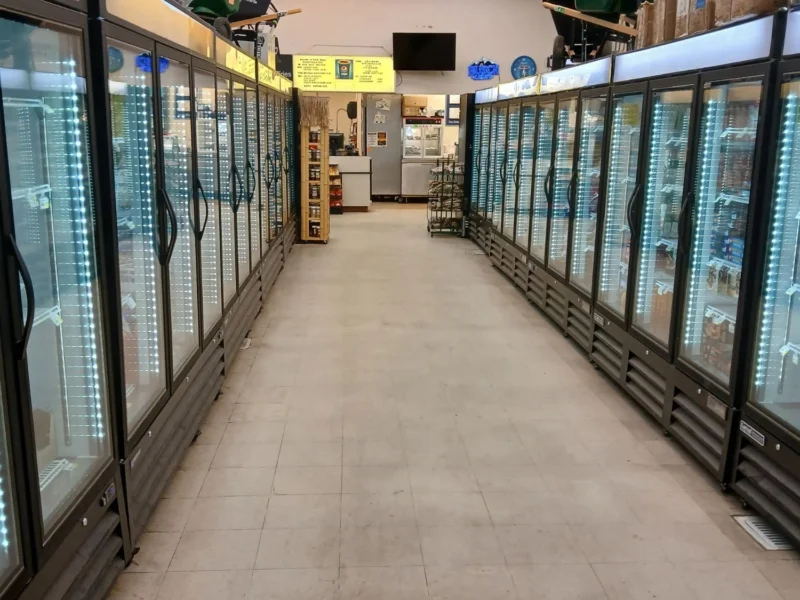 Frozen foods aisle lined with glass-door freezers at Tonto Basin Market