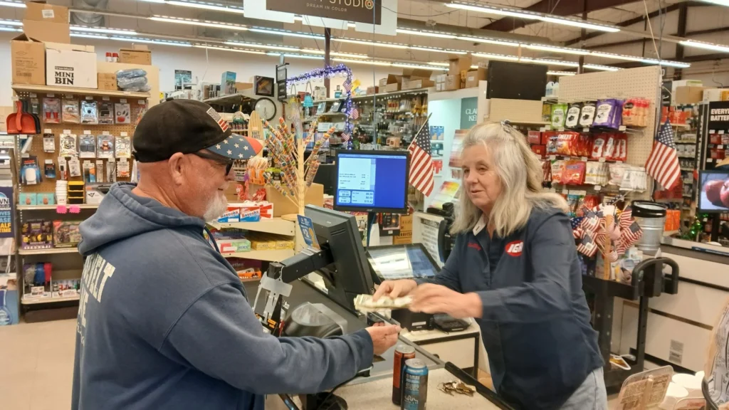 Store Manager Shelley Allison checking out a customer at the Tonto Basin Market register