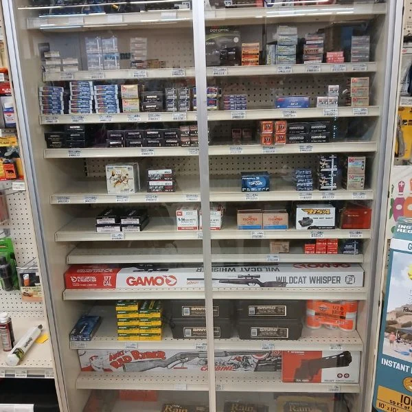 Sporting goods shelves with ammunition and a Gamo air rifle at Tonto Basin Market